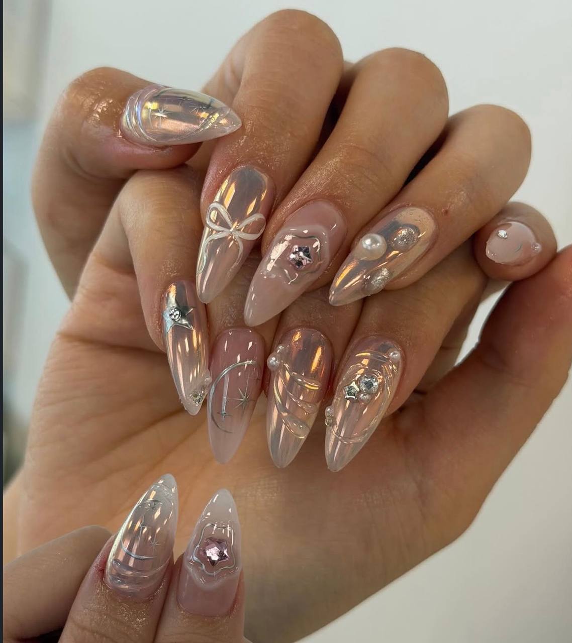 Chrome 3D nails with bow and pearl details