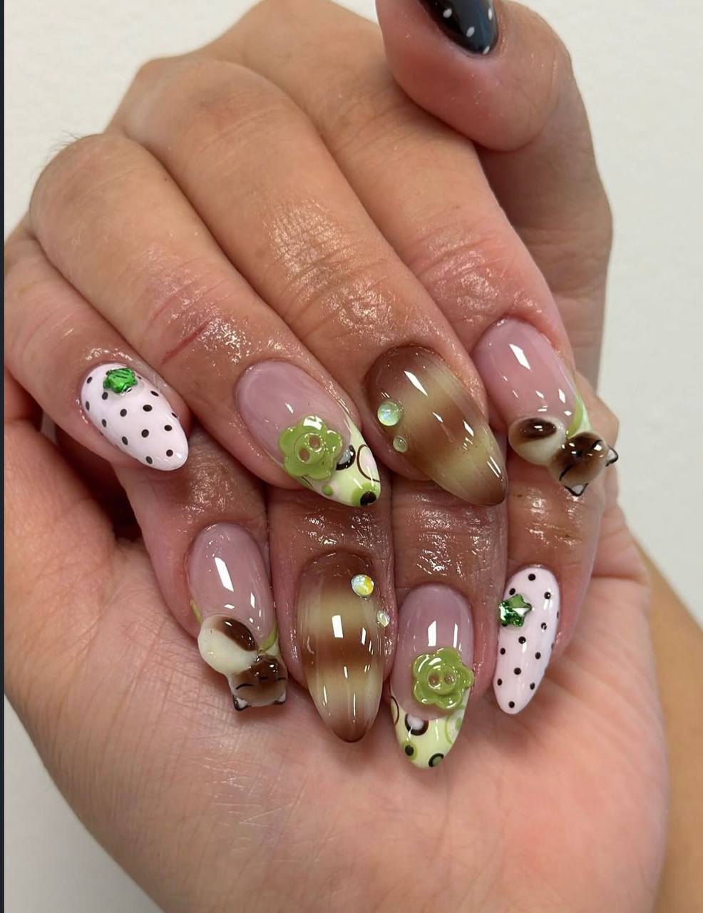 3D floral nail art with green flowers and charms